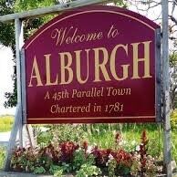 Welcome to Alburgh sign flower box in the summer